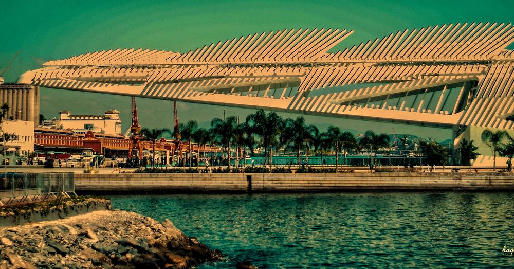 Bridge over river against sky in city