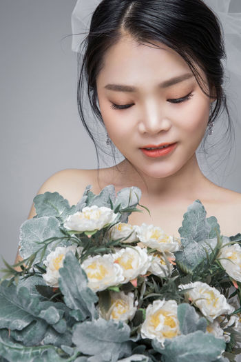 Close-up of woman holding rose bouquet