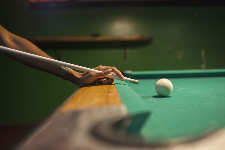 A young woman playing pool.