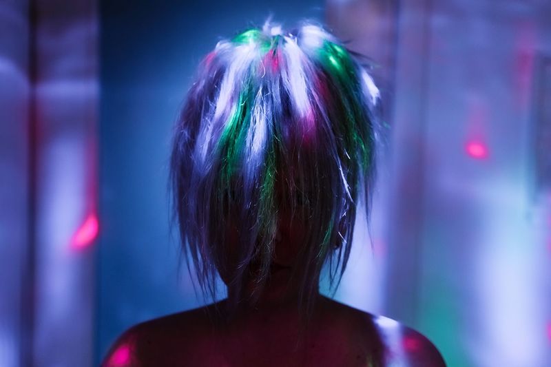 Close-up of woman in disco lights