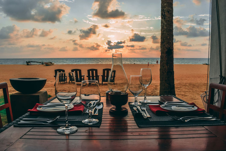 Place setting on table against beach