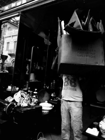 Rear view of man working at market stall in city