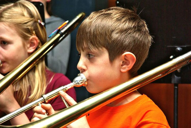 Girl and boy playing trombone