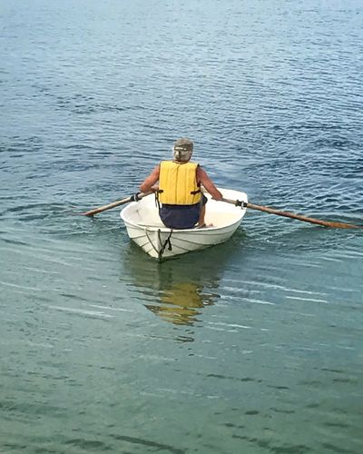 Man sitting in boat on water