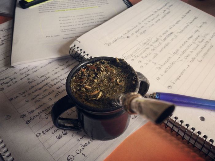High angle view of yerba mate on open books
