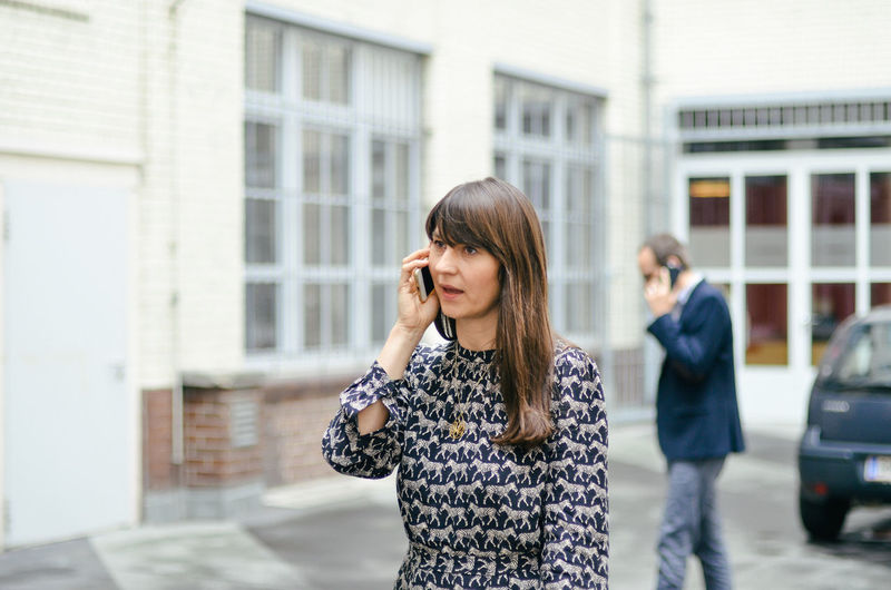 Professional woman using mobile phone in city