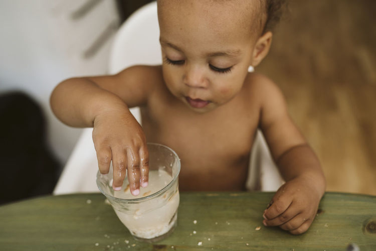 Toddler playing with drink