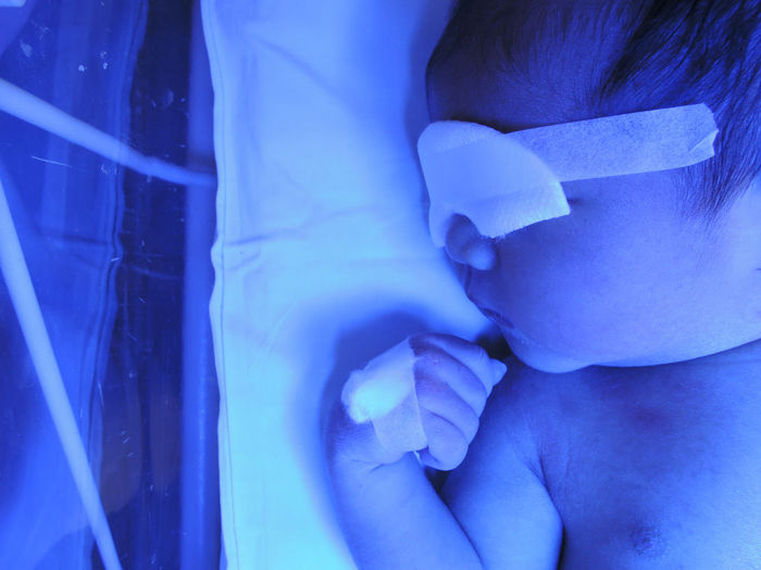 Close-up of baby in newborn care unit