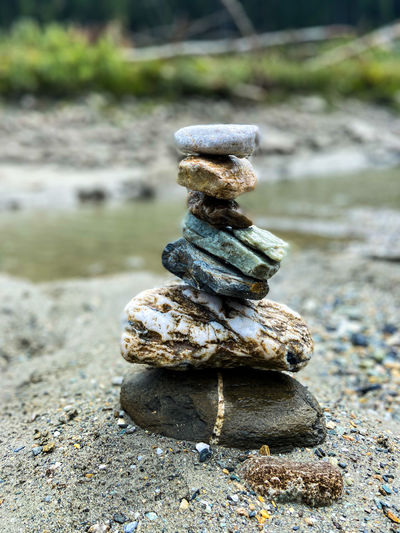 Close-up of stone stack on rock at beach