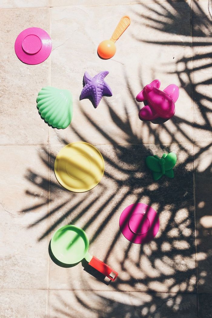 High angle view of plastic toys on floor during sunny day