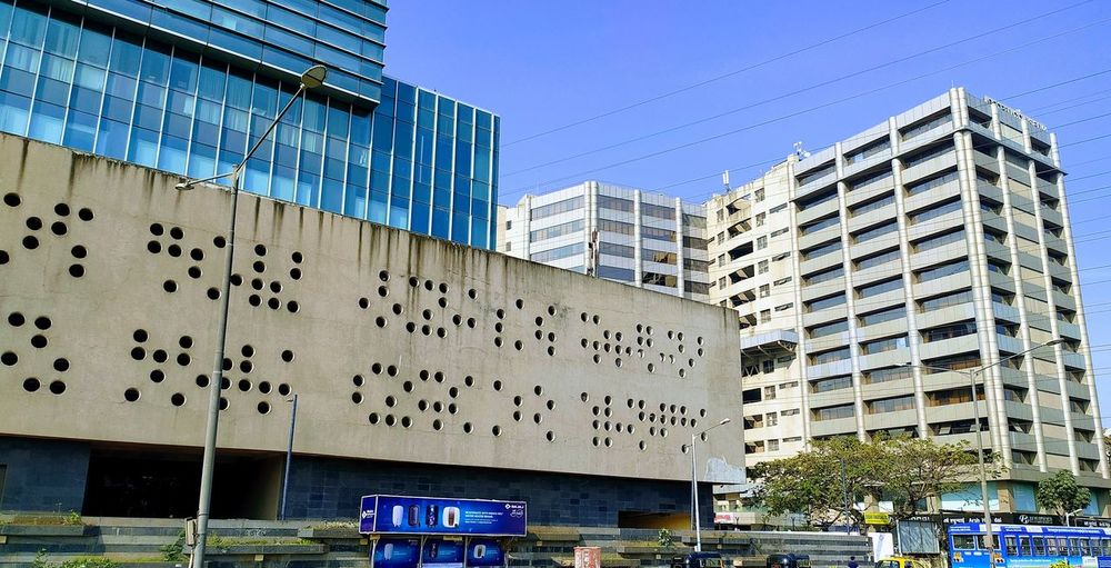 Low angle view of modern buildings against clear blue sky