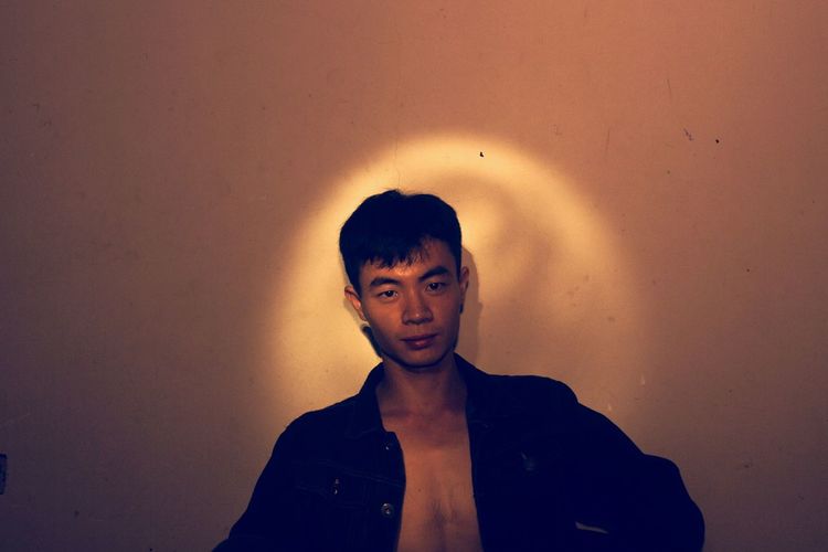 Man standing against wall