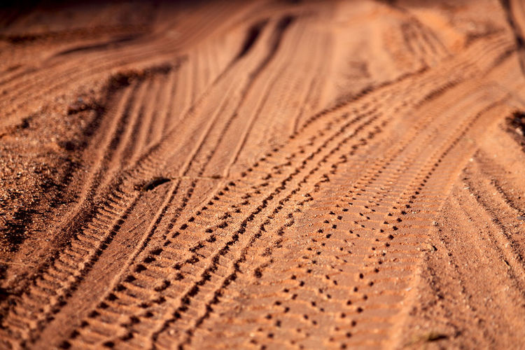 Detail shot of tire tracks on sand