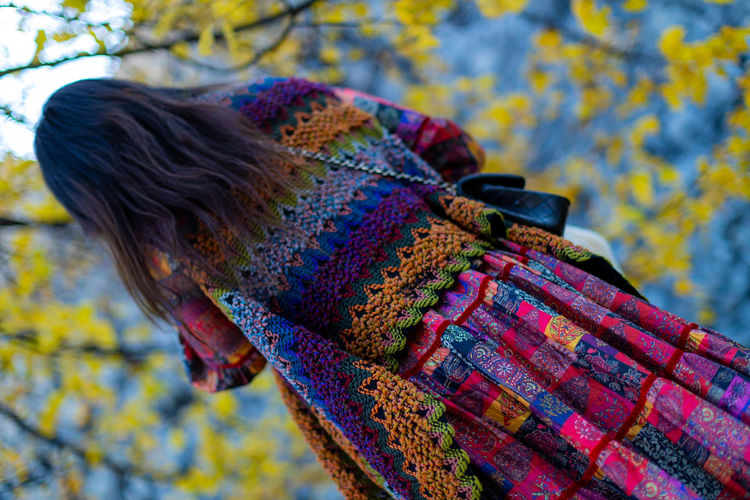 Close-up of woman with multi colored umbrella during autumn