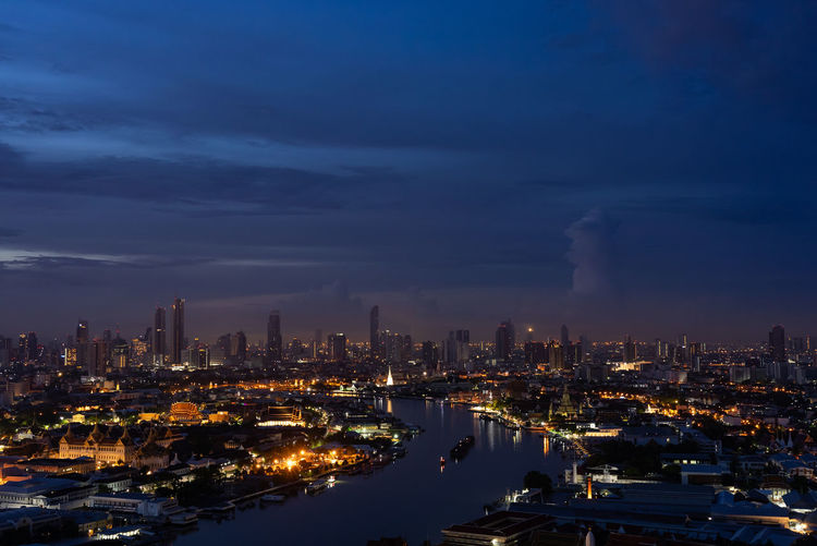 High angle view of illuminated cityscape against sky during sunset