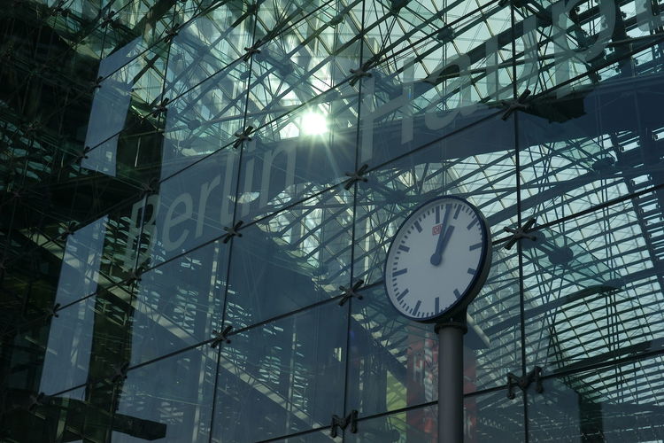 Low angle view of clock on glass building