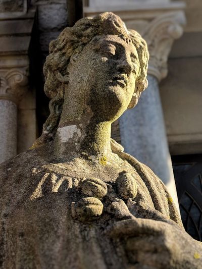Low angle view of old female statue