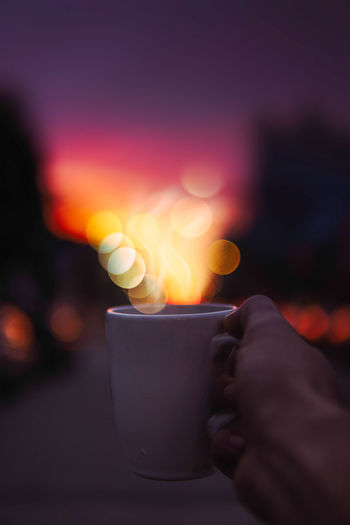 Close-up of hand holding tea cup