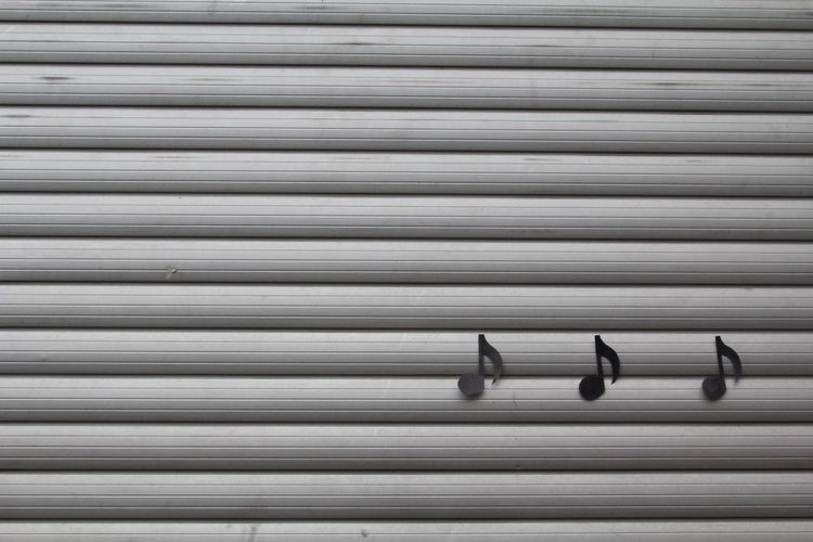 Musical note symbols on patterned wall