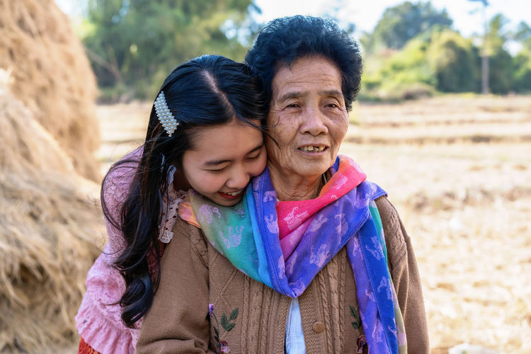 Portrait of a smiling young woman and her grandmother
