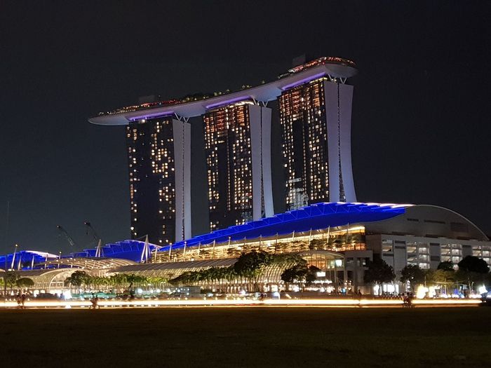 Illuminated modern building against sky at night