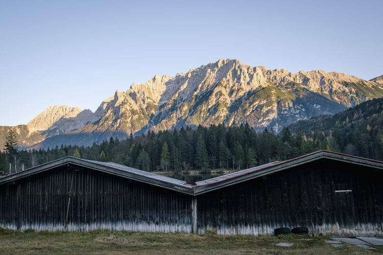View of built structure against trees and mountains