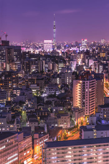 High angle view of illuminated buildings against sky at night