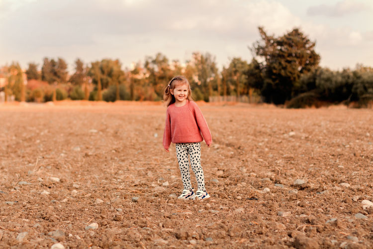 Young woman standing on field