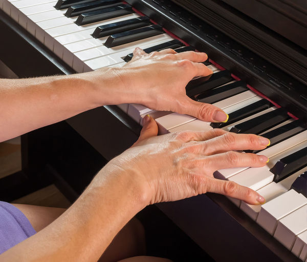 Low angle view of hands playing piano