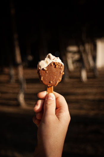 Close-up of hand holding ice cream cone