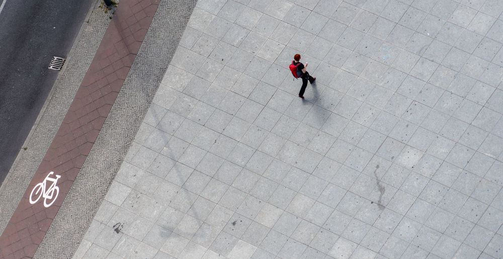 High angle view of woman walking on footpath