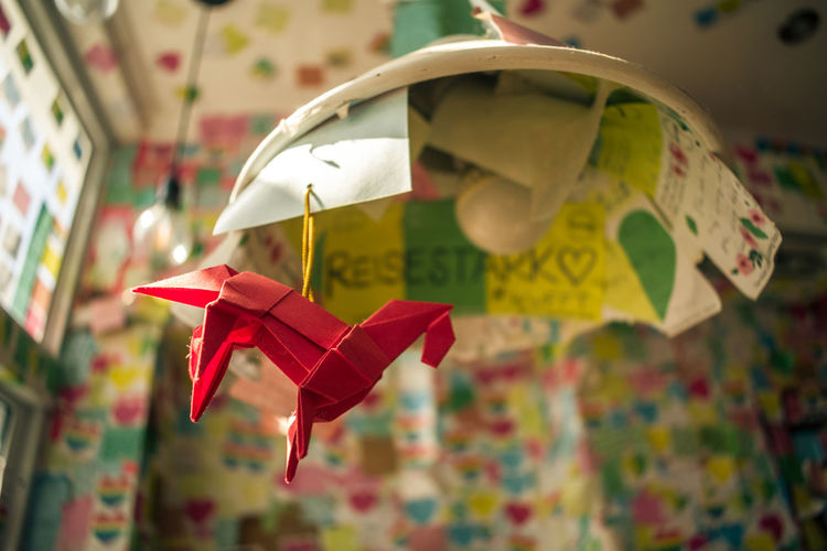 Close-up of toys hanging on paper