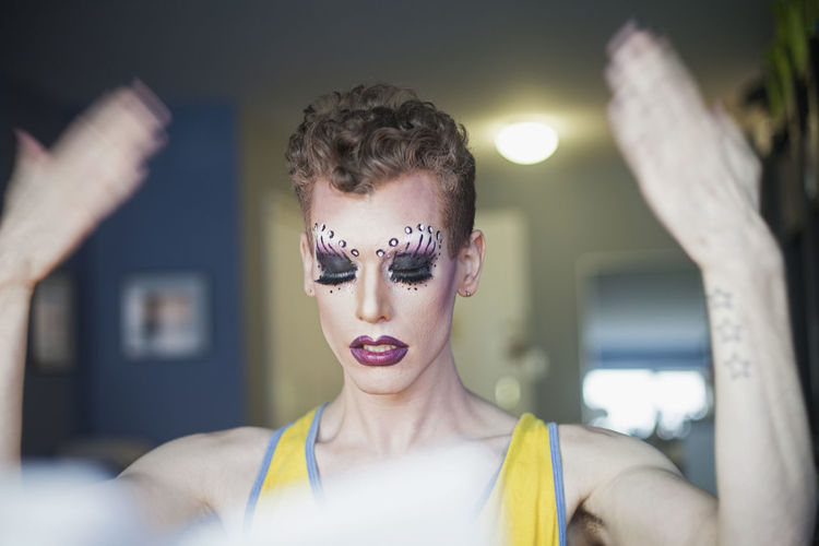 Young man letting drag makeup dry