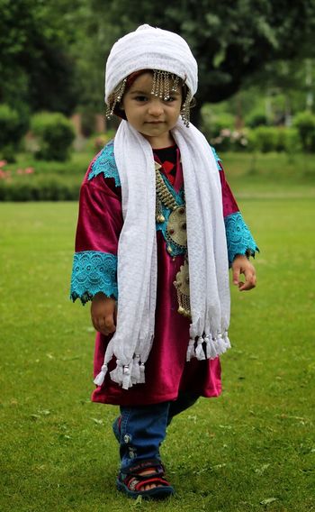 Portrait of girl standing in traditional clothing at park