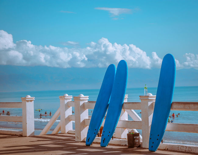 Surfboards against sea at beach