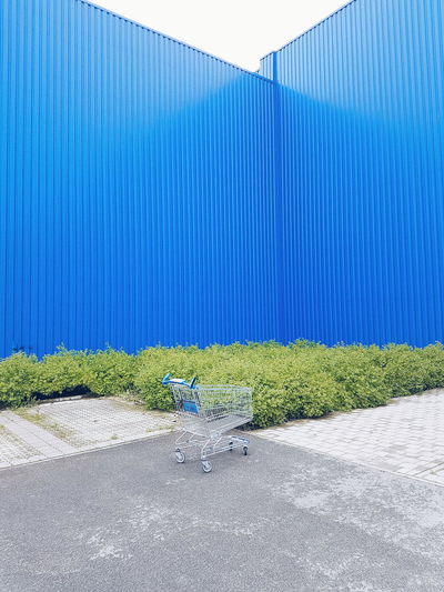 Empty chairs against blue wall