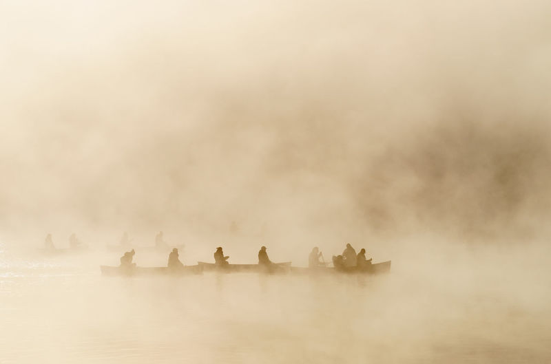 People in water against sky