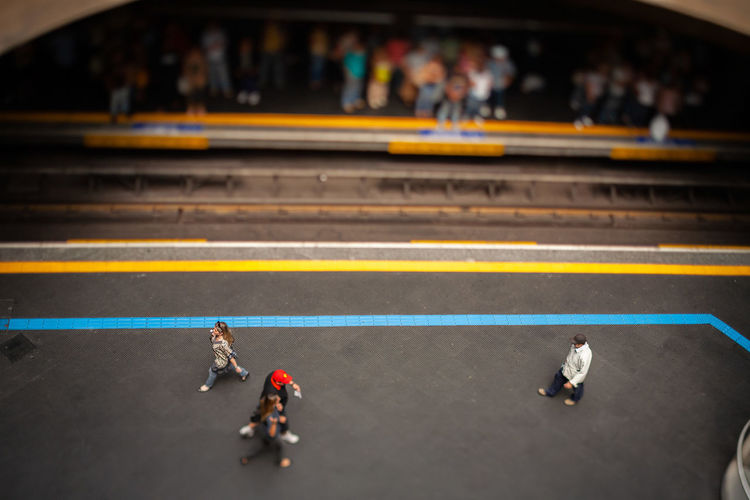 High angle view of people walking at railroad station platform