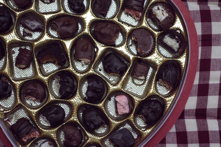 Directly above shot of half eaten chocolates on table