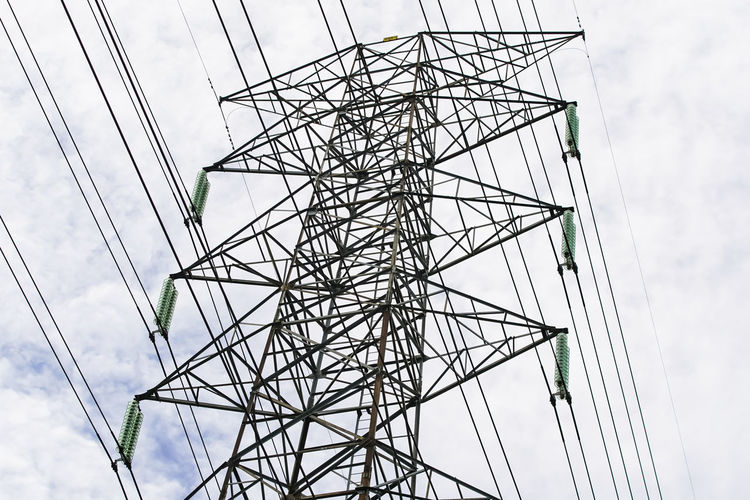 Low angle view of electricity pylon against sky
