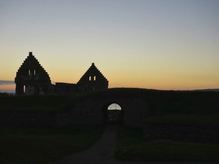View of built structures against clear sky at dusk