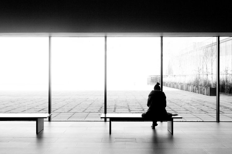Rear view of woman sitting on bench in national museum of modern and contemporary art