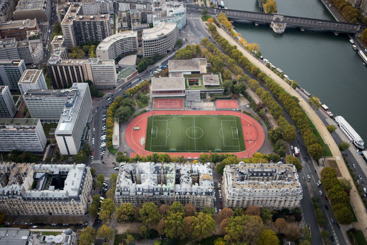 Aerial view soccer field in city by seine river