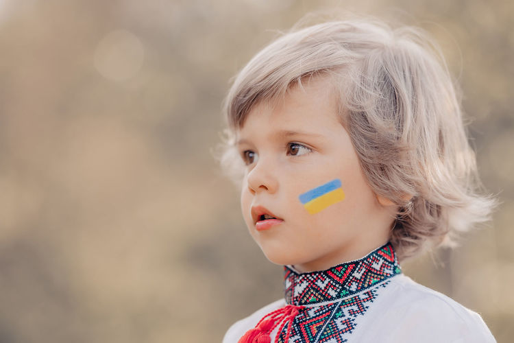 Boy with ukraine flag on face