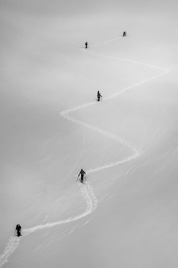 High angle view of people hiking on snowcapped mountain