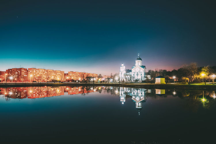 Reflection of illuminated buildings in lake