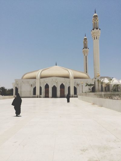 Women at mosque against clear sky
