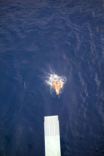 High angle view of woman diving into sea