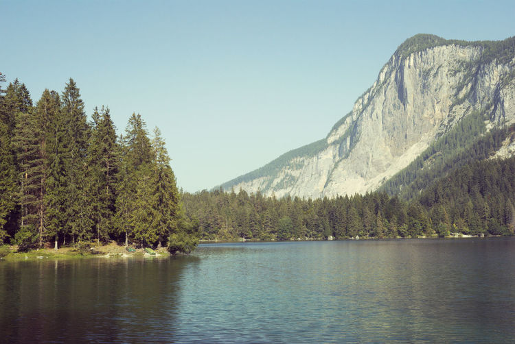 Scenic view of lake and mountains against clear sky