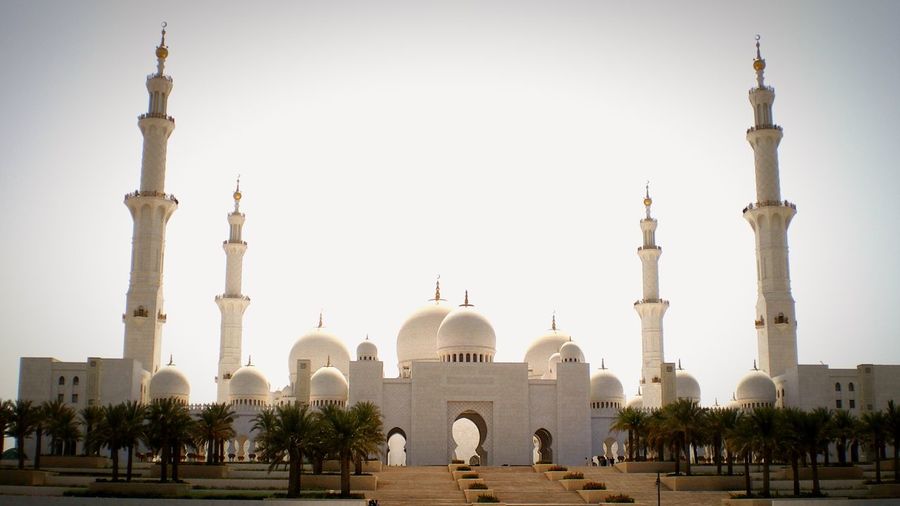 Low angle view of sheikh zayed mosque against clear sky on sunny day